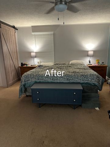 Bedroom after: smooth gray walls and a sliding barn door