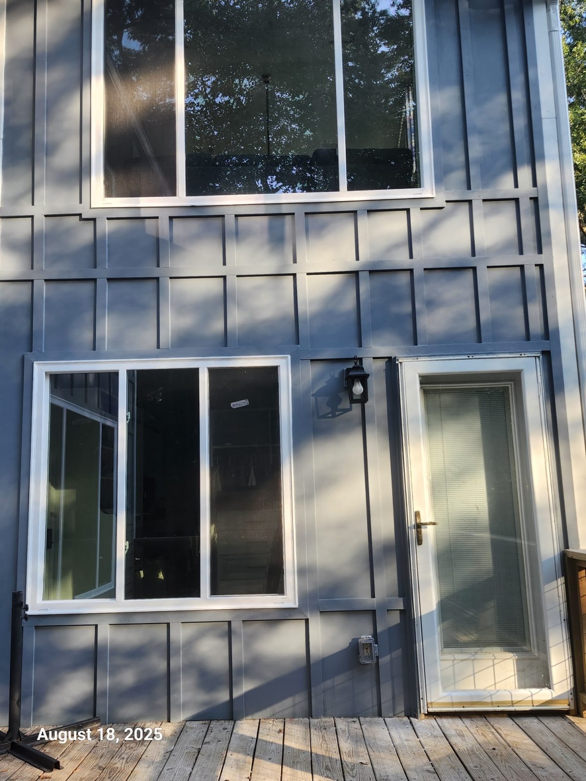 New board-and-batten siding around windows and a door