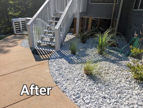 River rock bed with ornamental grasses beside the stairs