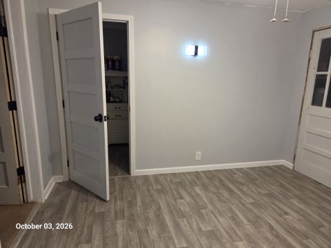 Room refresh with new wood-look flooring and white doors