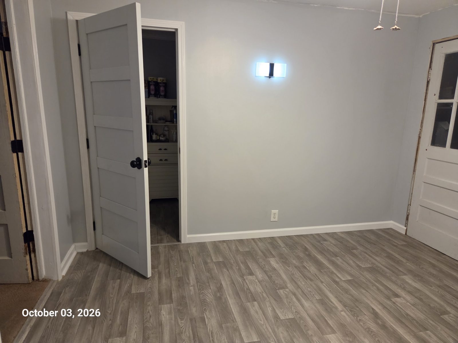Room refresh with new wood-look flooring and white doors